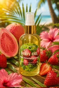 A bottle of body oil centered on a tropical beach backdrop with strawberries, pink hibiscus flowers, palm leaves, and ocean scenery around it. The bottle label reads 'The Candle Shop' and 'Body Oil' with 'Strawberry' visible on the front.